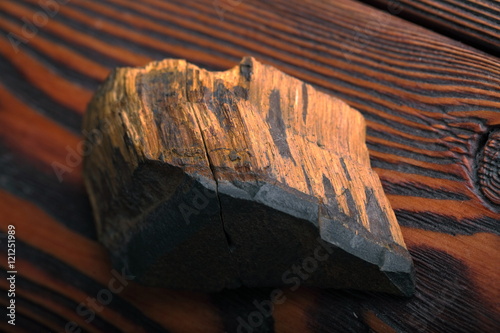 tiger's eye mineral on a dark wooden background photo