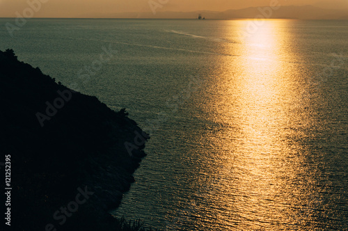 Sunset sunlight reflected in ocean photo