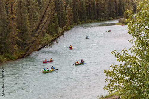Group of Canoeists on a River Through a Forest