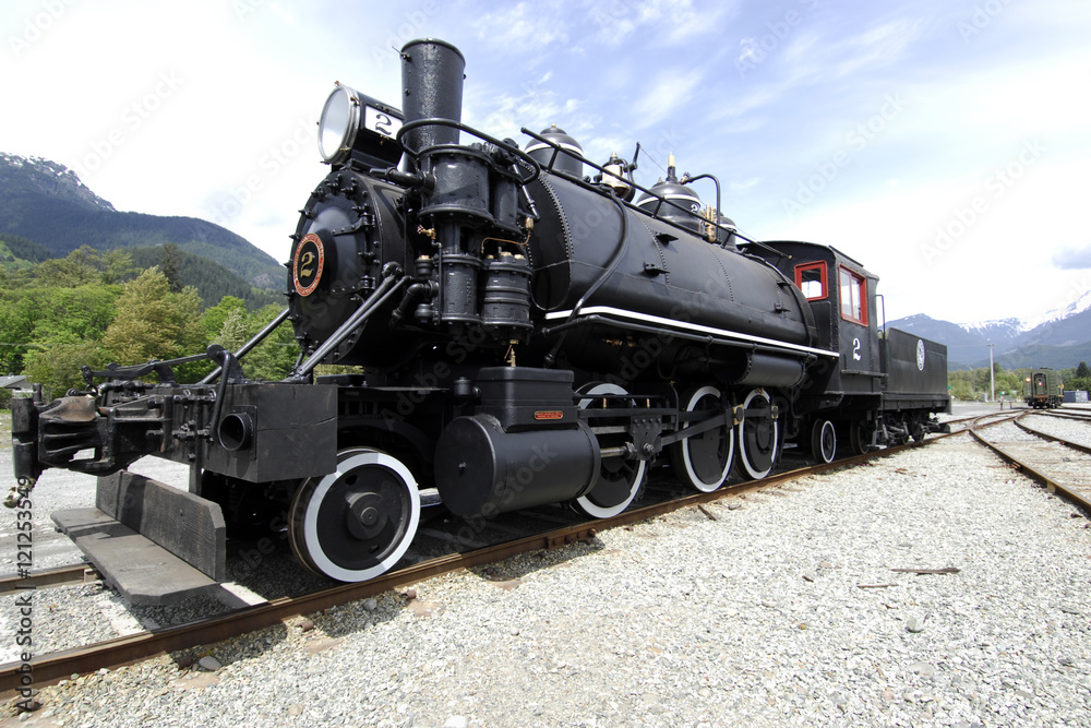 Fototapeta premium No 2 Steam Engine left side full on tracks with blue sky