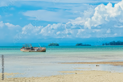 Old fisherman boat with anchor on the tropical beach © praisaeng
