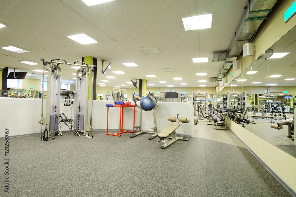 Fototapeta premium Interior of a fitness hall with sport equipment
