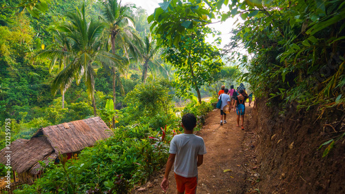 Local village hikers on lush jungle trail - Panay, Philippines