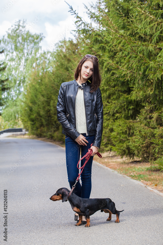 young girl on a walk with her dachshund young girl on a walk with her dachshund