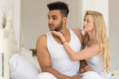 Young Couple Lying In Bed, Having Conflict Problem, Sad Negative Emotions Unhappy Hispanic Man And Woman