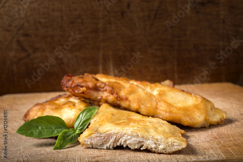 Obraz na płótnie Fried chicken schnitzel with basil