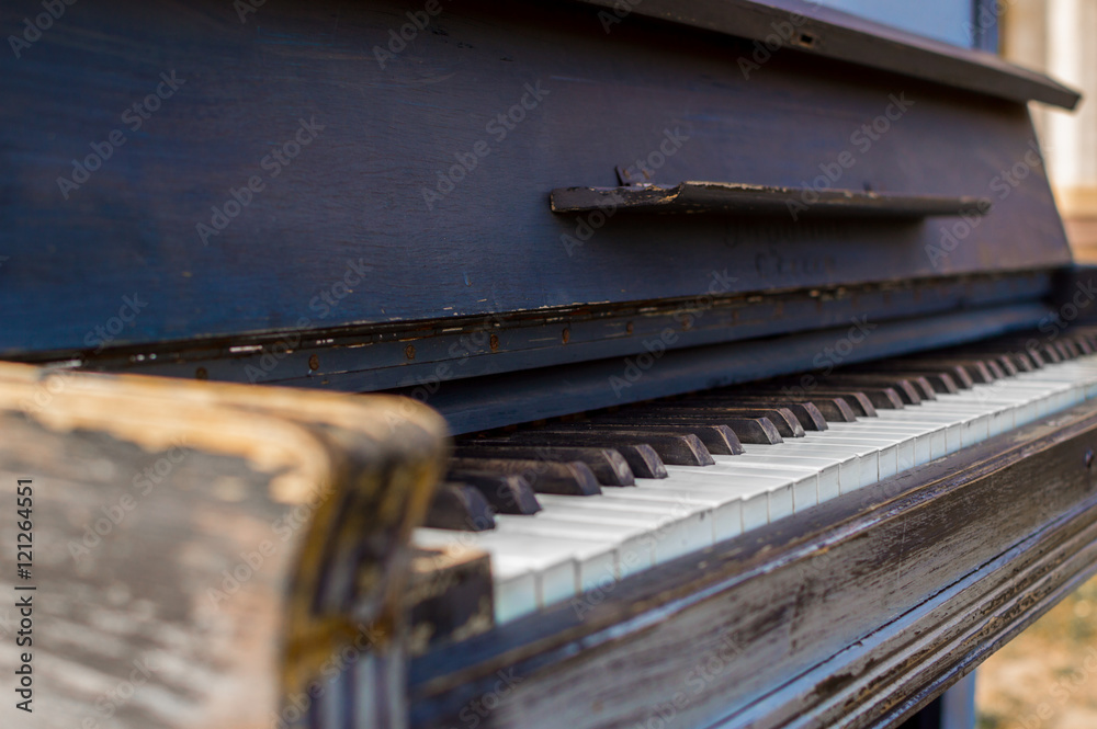 Old piano painted in blue color on the street Old piano painted in blue color on the street
