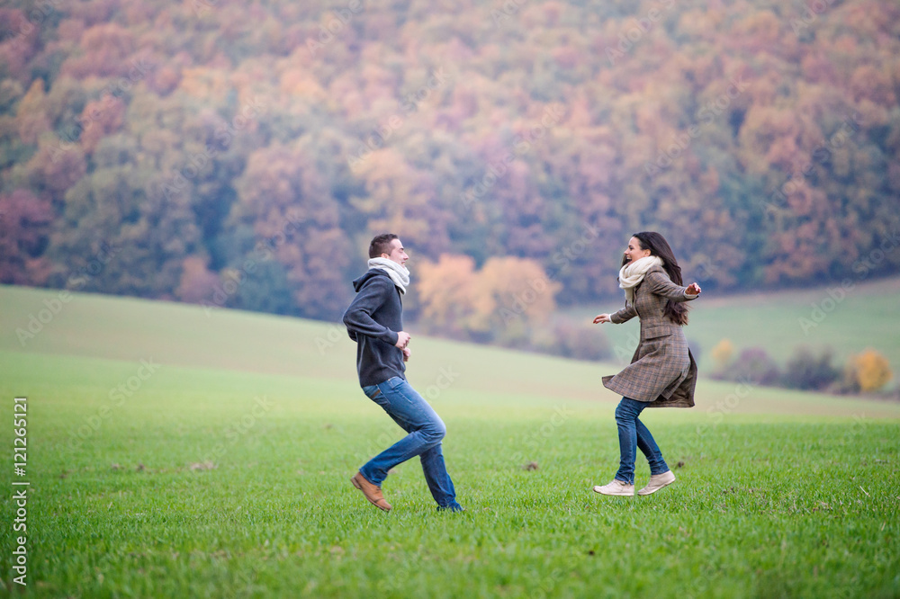 Beautiful young couple on a walk. Colorful autumn nature. Beautiful young couple on a walk. Colorful autumn nature.