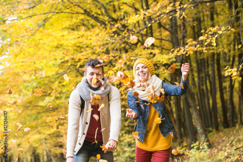 Beautiful couple on a walk in autumn forest