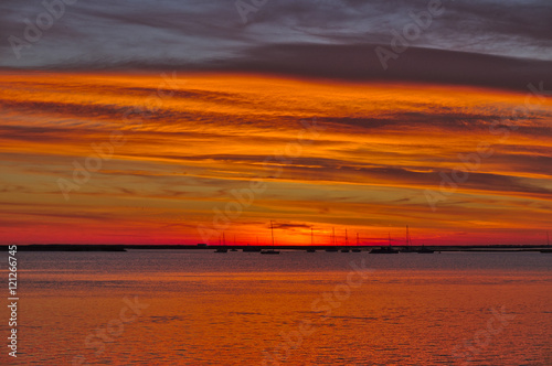 Sailing boats in Ria Formosa right after sunset. Faro, Algarve, Portugal