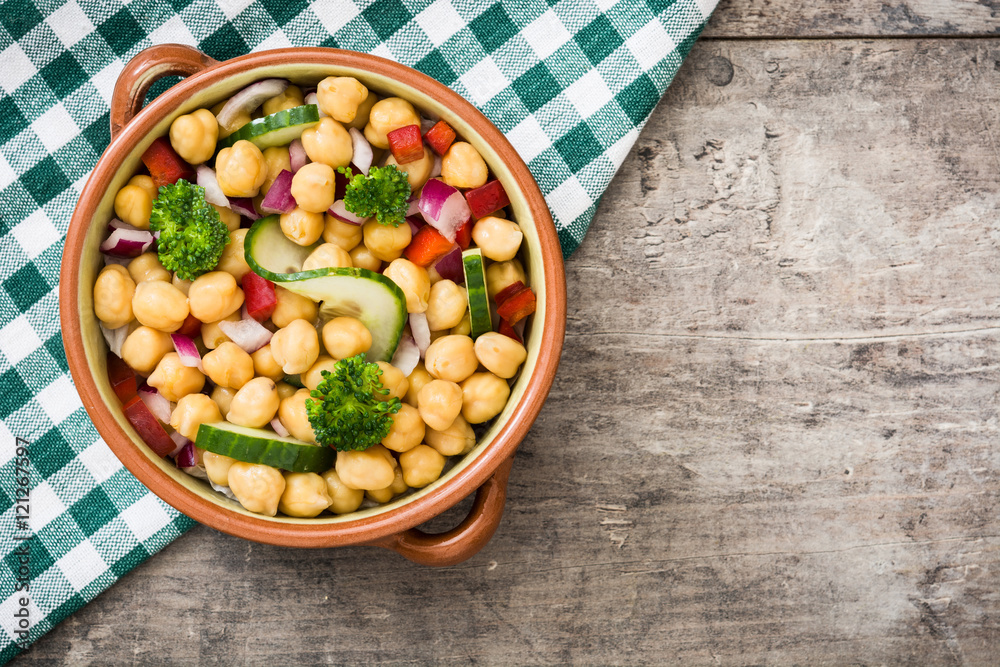 Chickpea salad in bowl on wooden background
Chickpea salad in bowl on wooden background