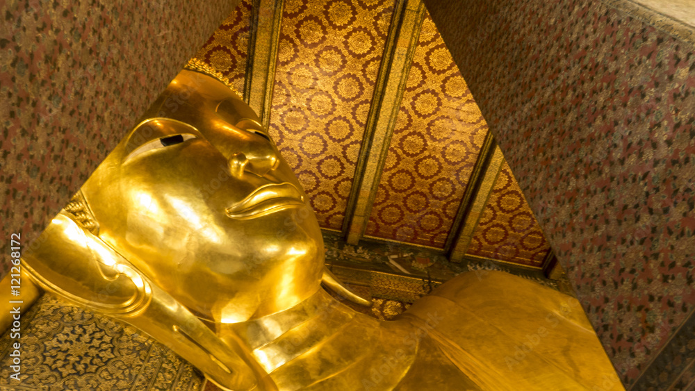 Face of Reclining Buddha,and thai art architecture in Wat Phra Chetupon Vimolmangklararm (Wat Pho) temple in Thailand.