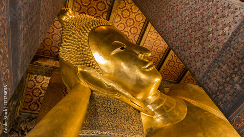 Face of Reclining Buddha,and thai art architecture in Wat Phra Chetupon Vimolmangklararm (Wat Pho) temple in Thailand.