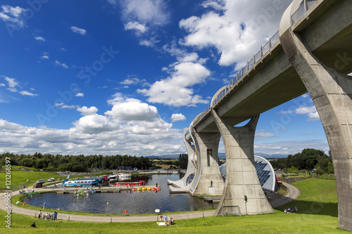 Falkirk Wheel with blue sky in Falkirk Scotland. The Wheel is a rotating boat lift connecting the Forth and Clyde Canal with the Union Canal photo