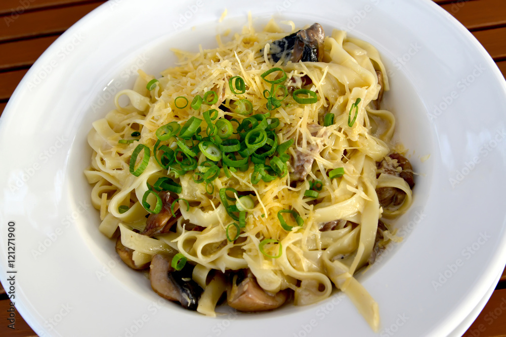 The Italian paste with mushrooms in creamy sauce - tagliatelle.