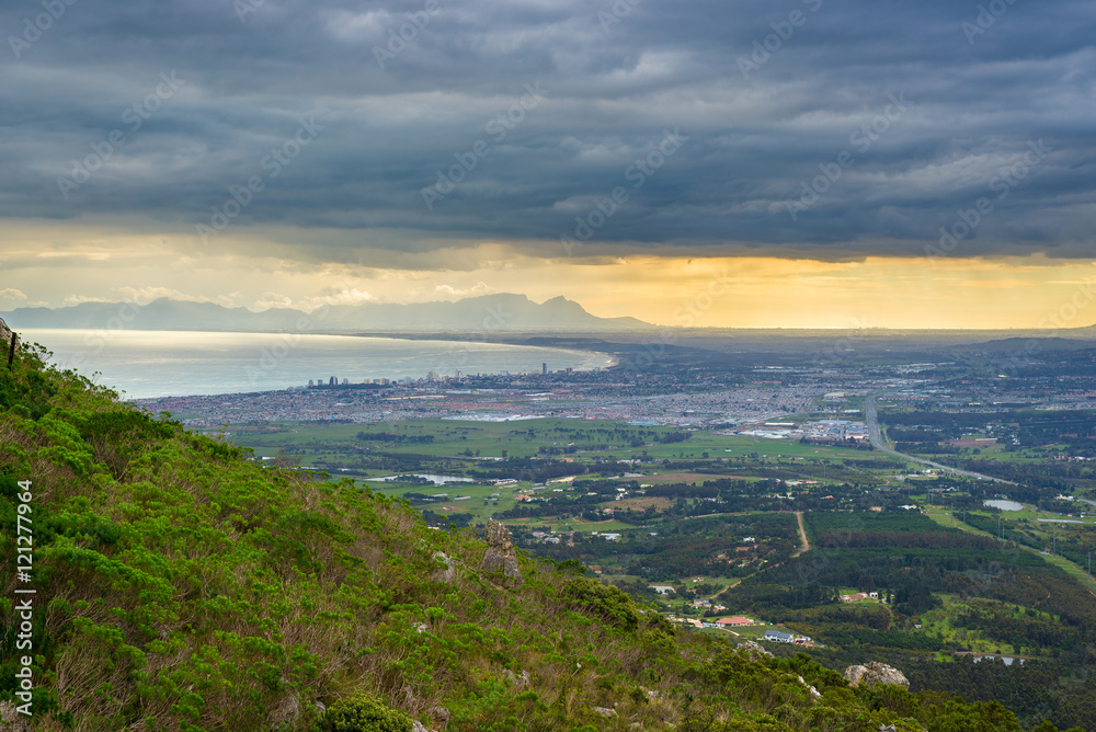 Aerial view of Cape Town from Sir Lowry's Pass, South Africa. Winter season, cloudy and dramatic sky.