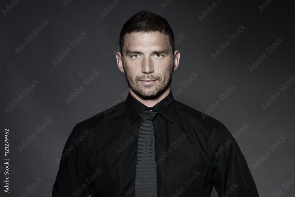 young business man in studio in black shirt young business man in studio in black shirt