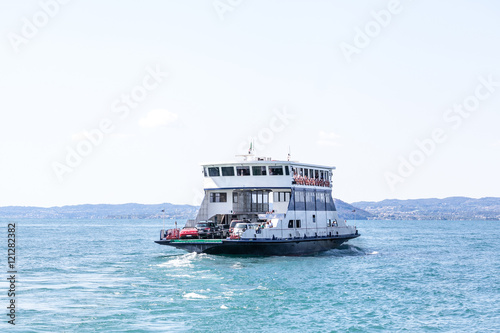 Ferry boat transporting cars on a lake Lago di Garda