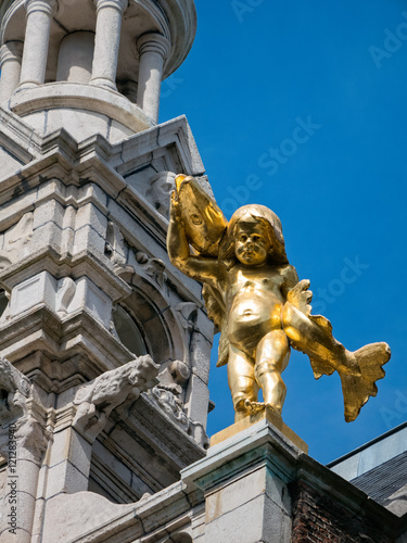 Golden statue on building in Antwerp photo