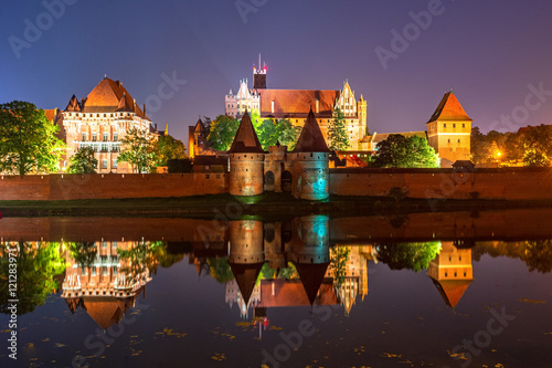 Malbork Castle from across the Nogat river at night. Poland. Europe. photo