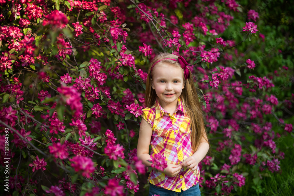 portrait of a happy girl in a flowered garden
