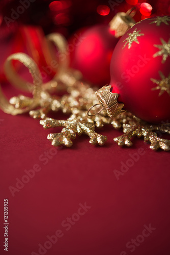 Red and golden christmas ornaments on red xmas background with copy space