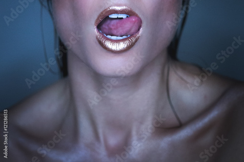 Woman Flicking Tongue Wearing Bronze Metallic Lipstick