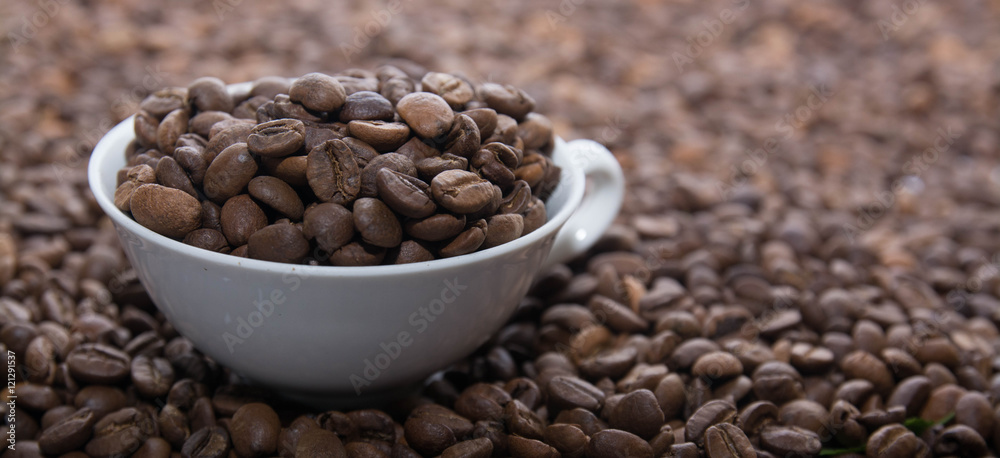 Fototapeta premium Cup with Beans on White Background