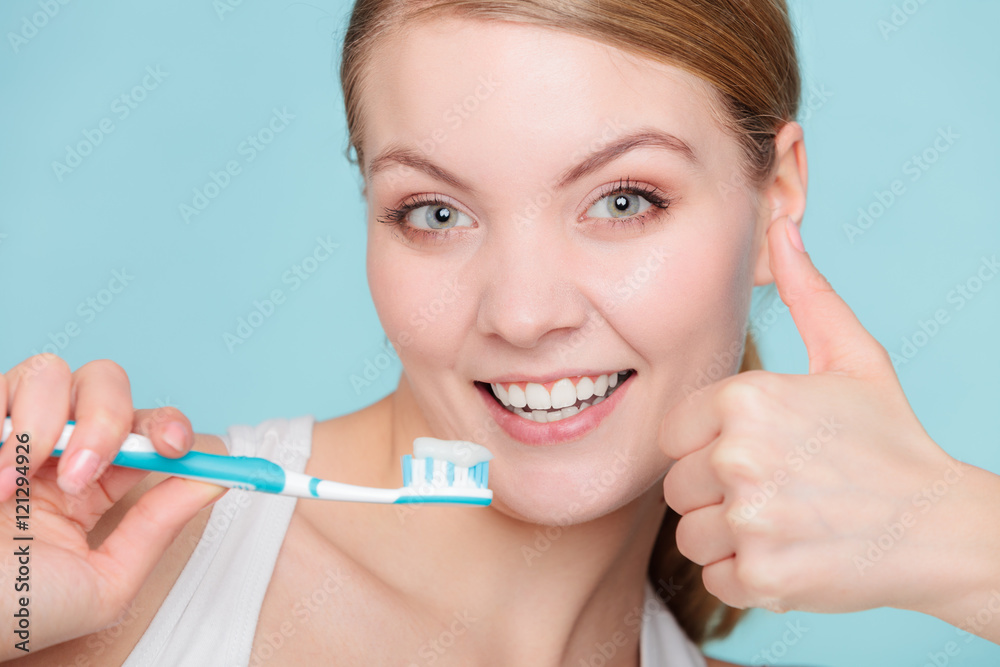 woman holds toothbrush with toothpaste cleaning teeth woman holds toothbrush with toothpaste cleaning teeth