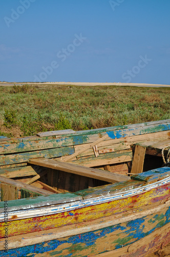 Old wooden boat on the sand, with paint washed and peeling off © ADV Photos