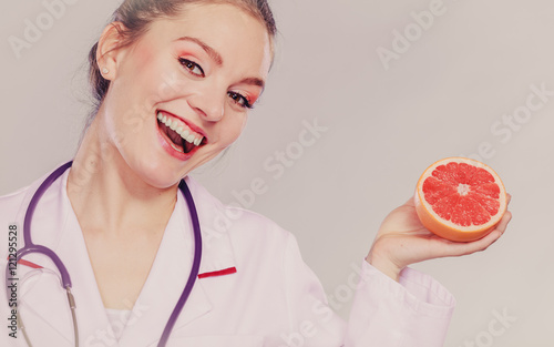 Happy dietitian nutritionist with grapefruit.