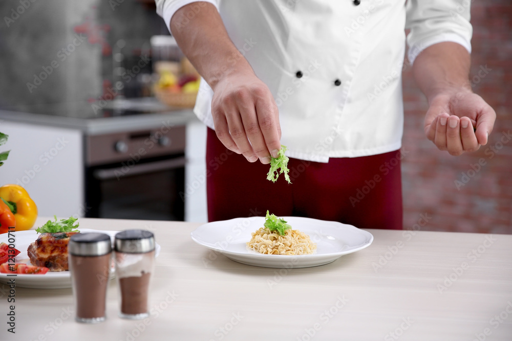 Young handsome chef cook preparing pasta in kitchen Young handsome chef cook preparing pasta in kitchen