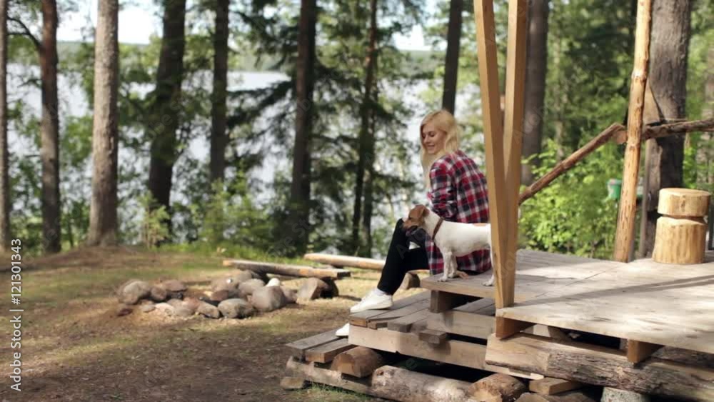 Beautiful Woman With Dog Sitting in a Large Tent in the Woods Beautiful Woman With Dog Sitting in a Large Tent in the Woods