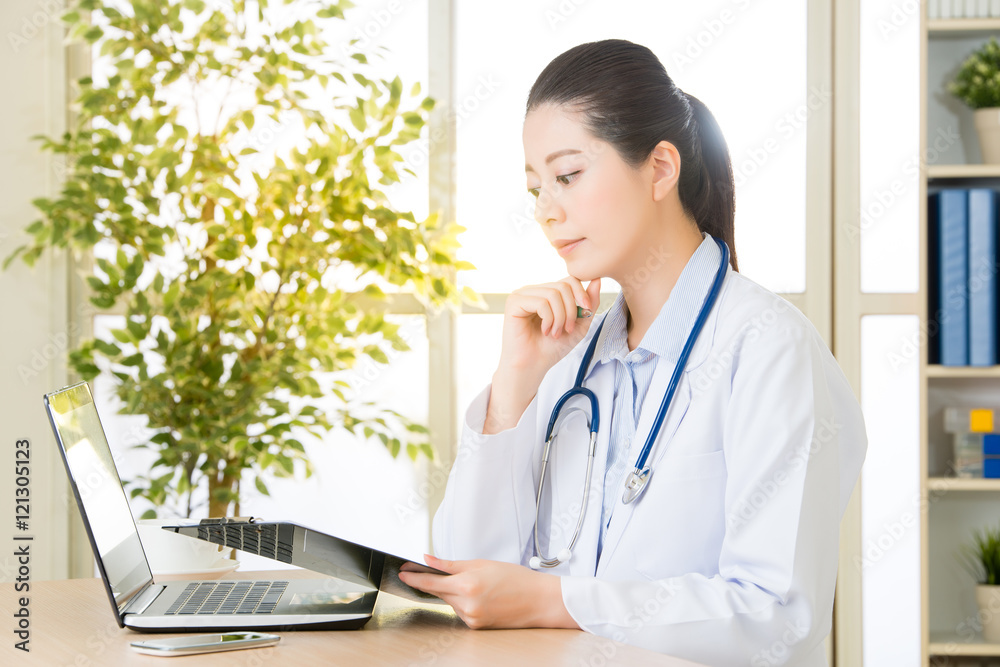 Doctor recording patient's condition on clipboard from computer, Doctor recording patient's condition on clipboard from computer,