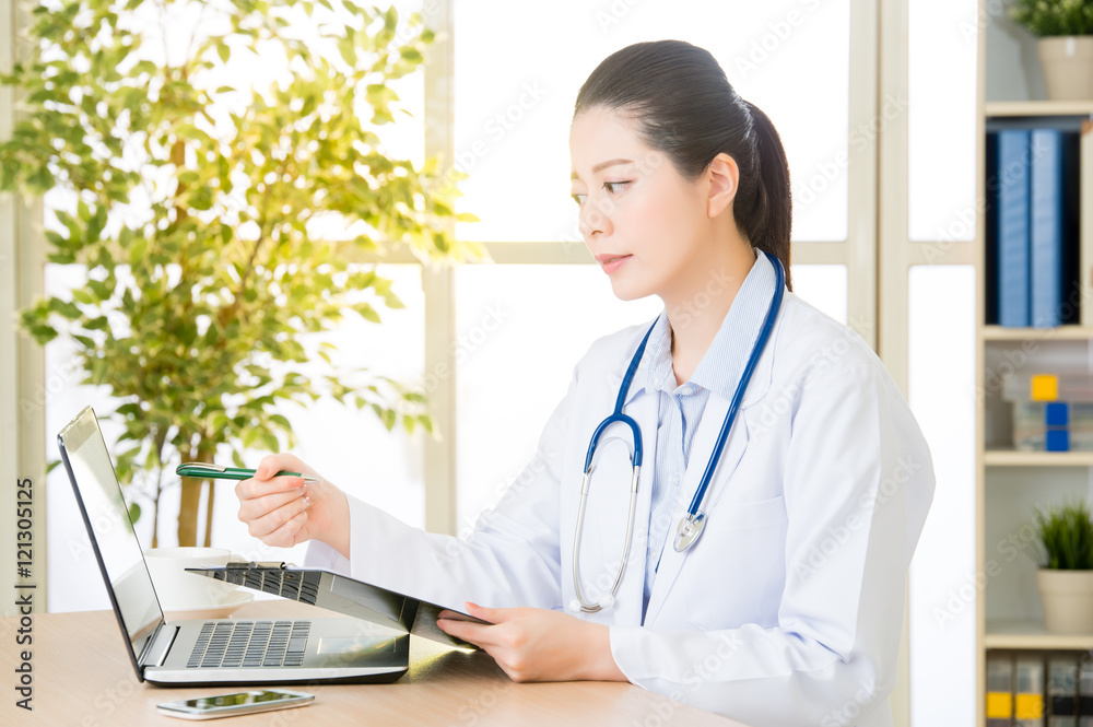 Doctor recording patient's condition on clipboard from computer, Doctor recording patient's condition on clipboard from computer,
