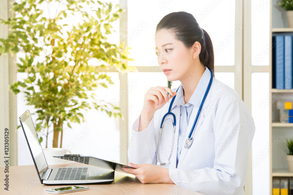 Doctor recording patient's condition on clipboard from computer, Doctor recording patient's condition on clipboard from computer,