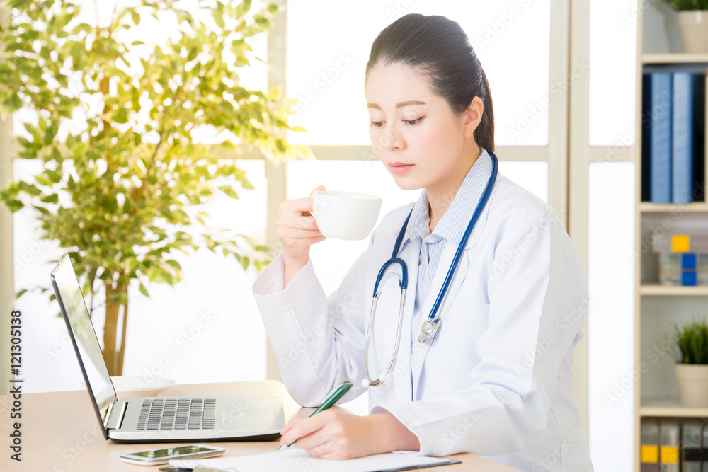 Doctor recording patient's condition on clipboard from computer, Doctor recording patient's condition on clipboard from computer,