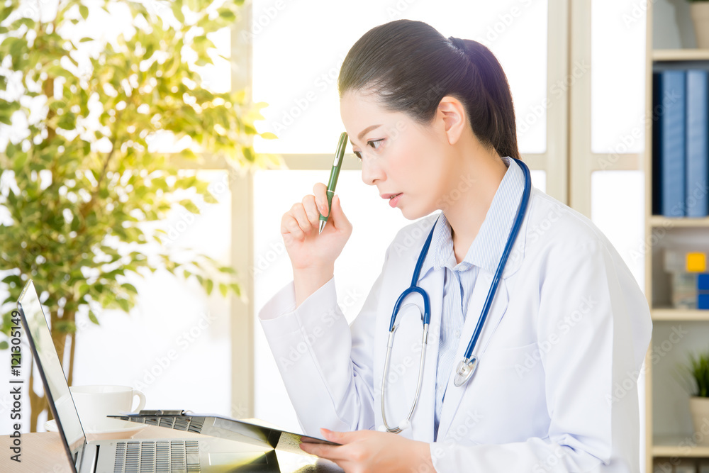 Doctor recording patient's condition on clipboard from computer, Doctor recording patient's condition on clipboard from computer,