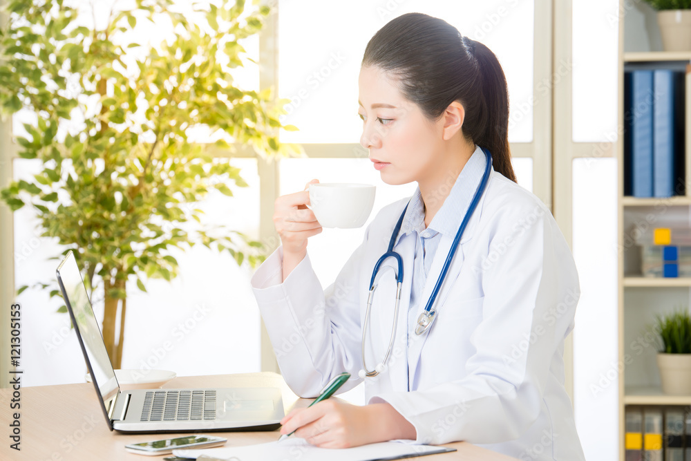 Doctor recording patient's condition on clipboard from computer, Doctor recording patient's condition on clipboard from computer,