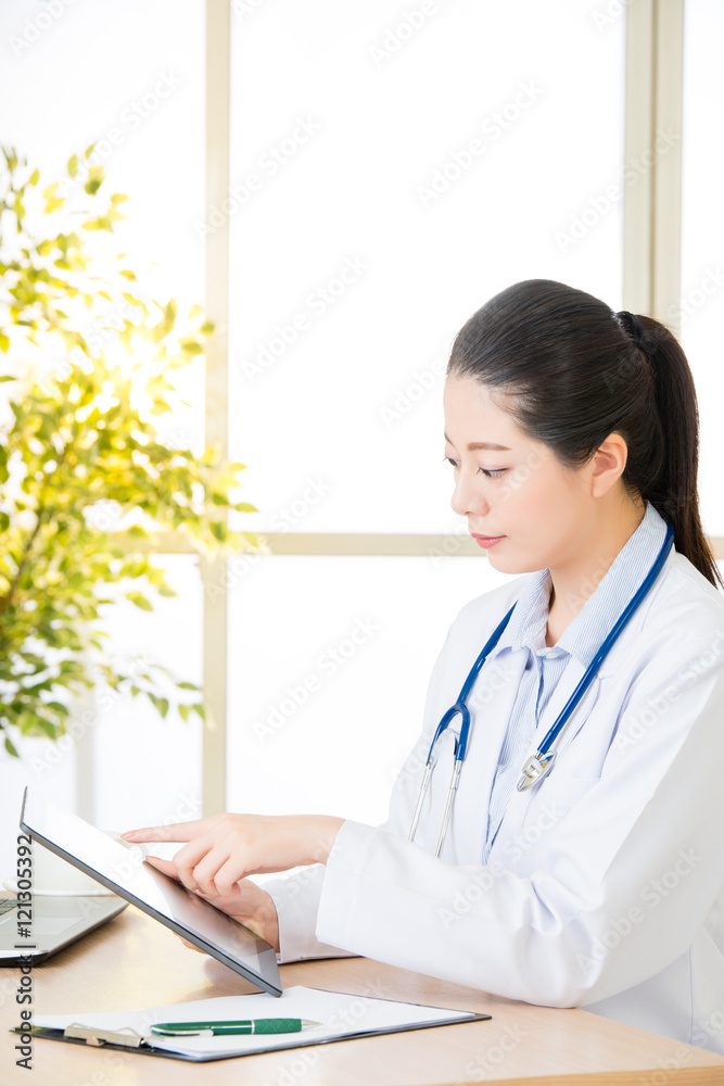 doctor using digital tablet to recording patient's medical case