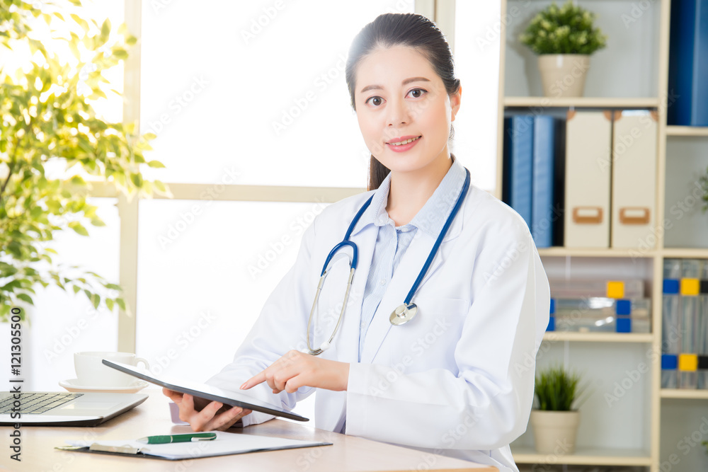 doctor using digital tablet to check patient's medical case doctor using digital tablet to check patient's medical case