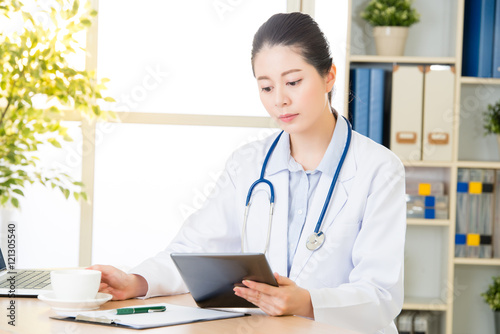 doctor drink coffee using digital tablet research patient's medi