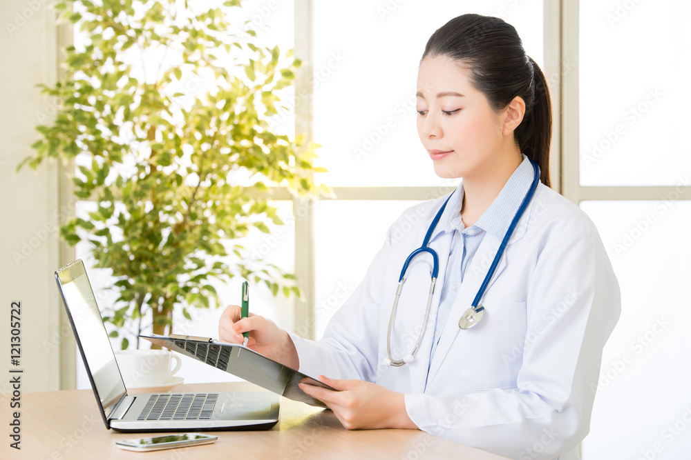 Doctor recording patient's condition on clipboard from computer, Doctor recording patient's condition on clipboard from computer,