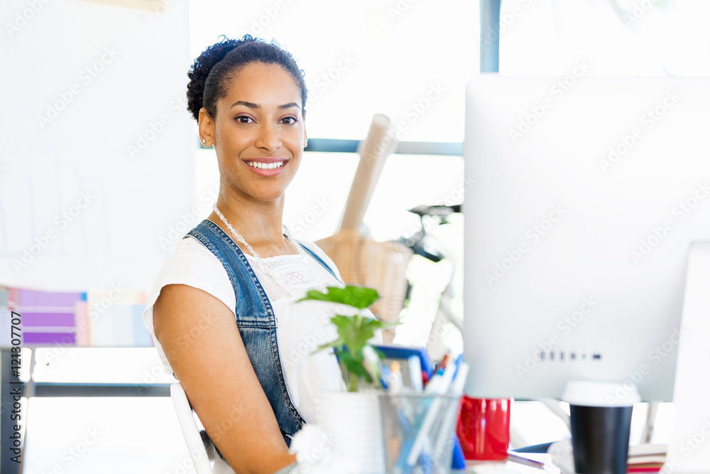 Portrait of smiling afro-american office worker sitting in offfice Portrait of smiling afro-american office worker sitting in offfice