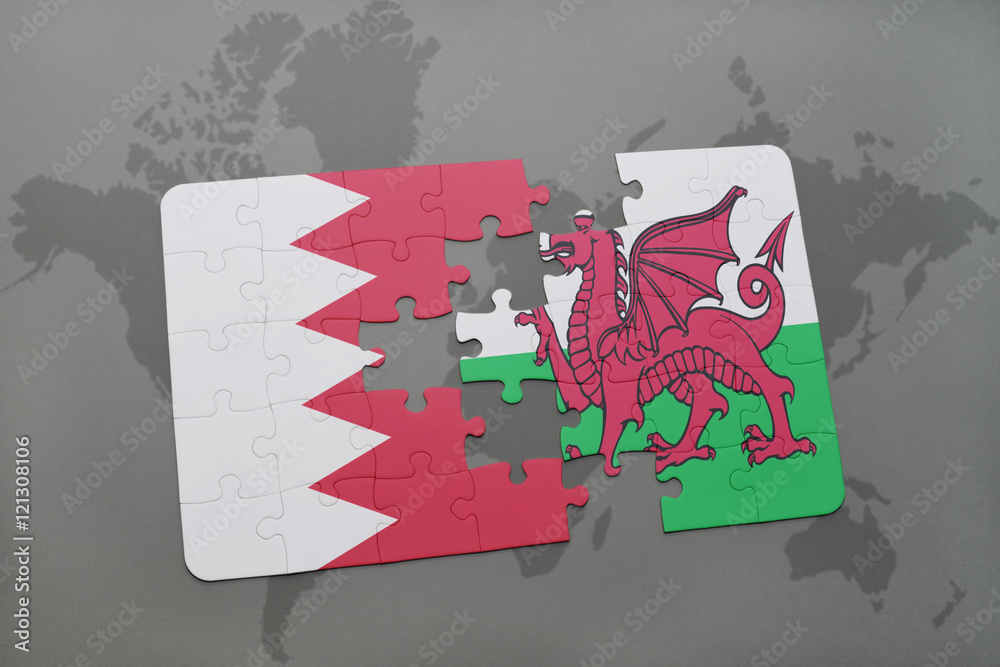 puzzle with the national flag of bahrain and wales on a world map background. puzzle with the national flag of bahrain and wales on a world map background.