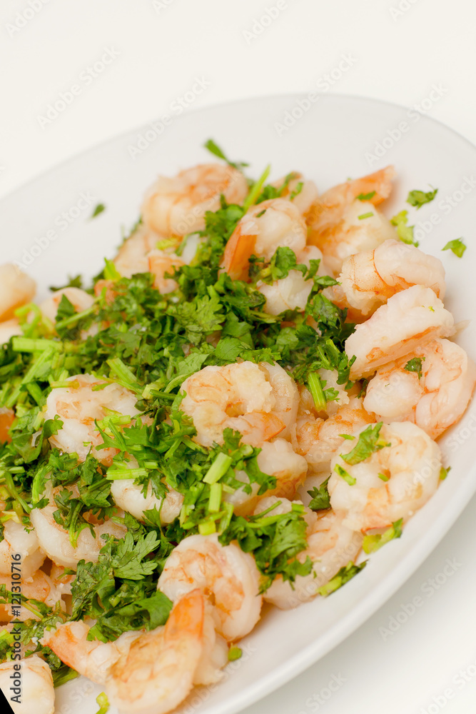 Fried shrimps with the greens. Easy seafood snack on white background close-up. Fried shrimps with the greens. Easy seafood snack on white background close-up.