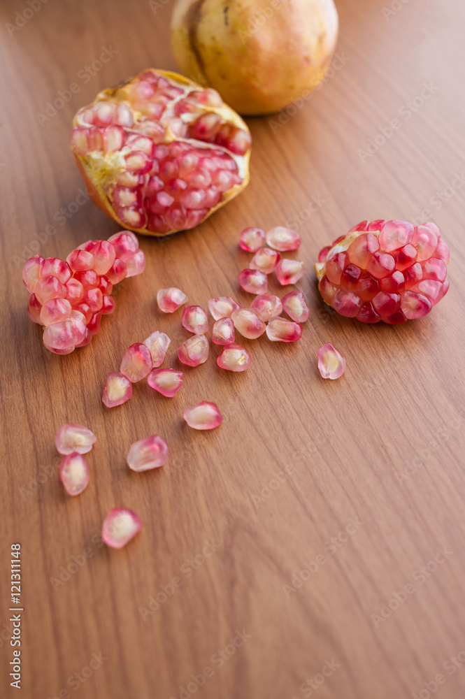 Ripe pomegranate fruit on wooden background Ripe pomegranate fruit on wooden background
