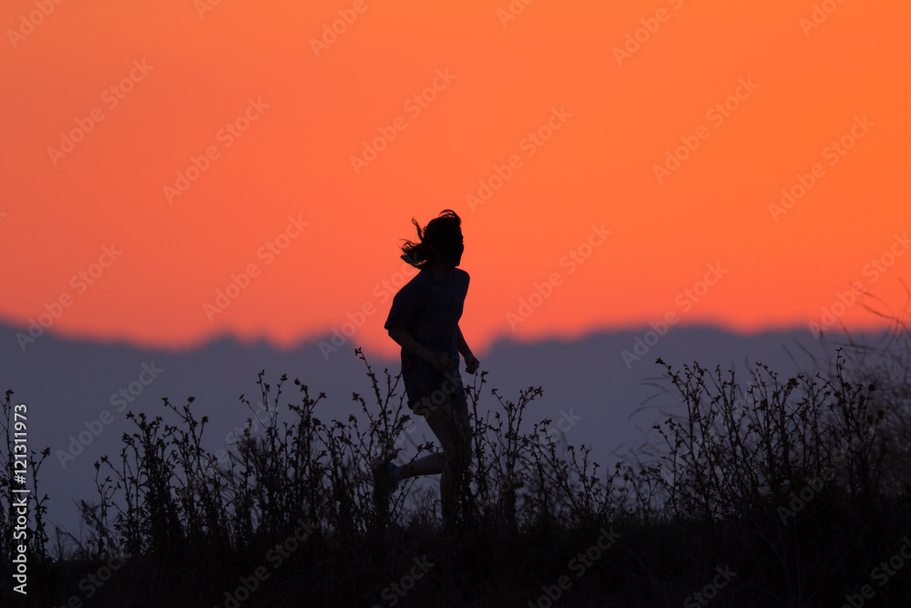 Runner against the Peninsula skyline in California, right after sunset.