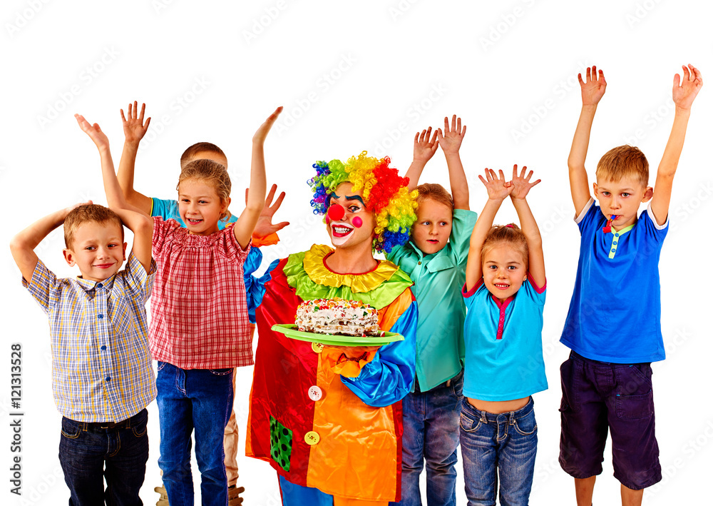 Fototapeta premium Clown keeps birthday cake with group children hands up. Isolated.
