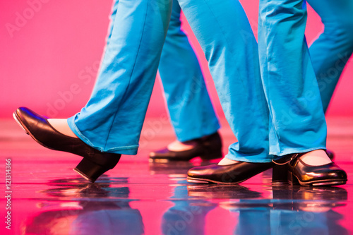 group of tap dancers feet on a shiny stage